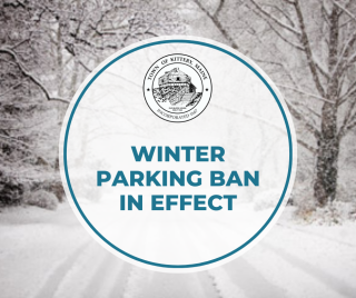 Image of snowy road with text: winter parking ban in effect