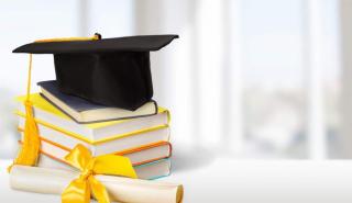 Image of a graduation cap and a diploma on a stack of colorful books