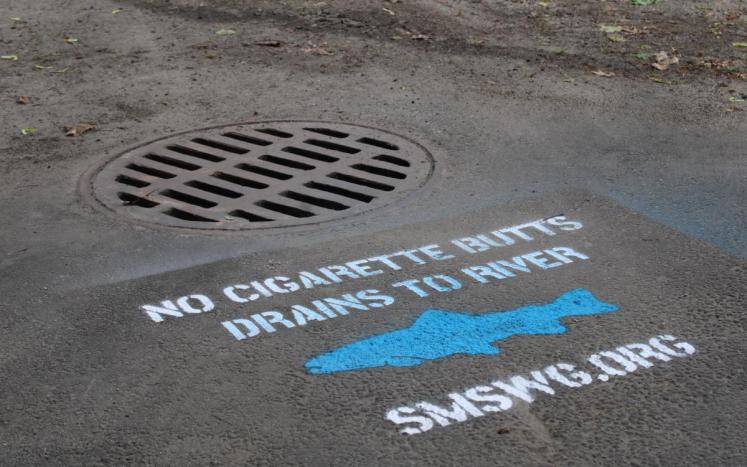 Photo of a blue and white painted stencil with stormwater information
